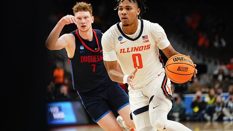 Mar 23, 2024; Omaha, NE, USA; Illinois Fighting Illini guard Terrence Shannon Jr. (0) dribbles the ball against Duquesne Dukes forward Jake Necas (7) during the second half in the second round of the 2024 NCAA Tournament at CHI Health Center Omaha. Mandatory Credit: Dylan Widger-USA TODAY Sports