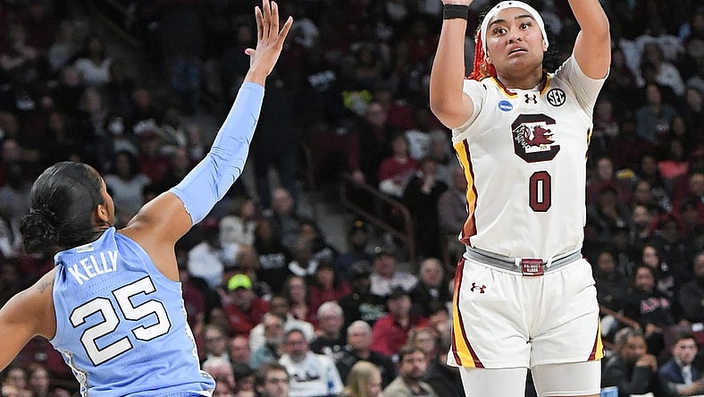 Mar 24, 2034; Columbia, So Carolina, USA;  South Carolina guard Te-Hina Paopao (0) makes a three-point shot near University of North Carolina guard Deja Kelly (25) during the second quarter of the second round NCAA Women's Basketball Tournament game at the Colonial Life Center.  Mandatory Credit: Ken Ruinard-USA TODAY Sports via Greenville News