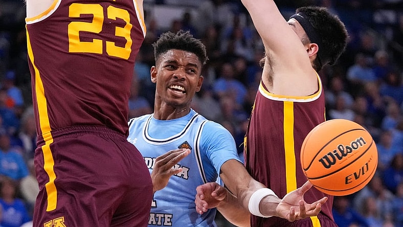 Indiana State Sycamores guard Julian Larry (1) passes the ball against Minnesota Golden Gophers forward Dawson Garcia (3) and Minnesota Golden Gophers forward Parker Fox (23) on Sunday, March 24, 2024, during the second round of the NIT at the Hulman Center in Terre Haute.
