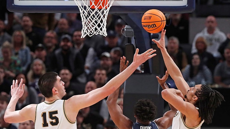 Purdue Boilermakers center Zach Edey (15), Utah State Aggies forward Nigel Burris (35) and Purdue Boilermakers forward Trey Kaufman-Renn (4) go for a rebound during NCAA Men’s Basketball Tournament game, Sunday, March 24, 2024, at Gainbridge Fieldhouse in Indianapolis.