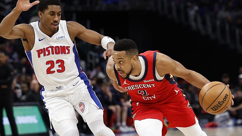 Mar 24, 2024; Detroit, Michigan, USA;  New Orleans Pelicans guard CJ McCollum (3) dribbles on Detroit Pistons guard Jaden Ivey (23) in the first half at Little Caesars Arena. Mandatory Credit: Rick Osentoski-USA TODAY Sports
