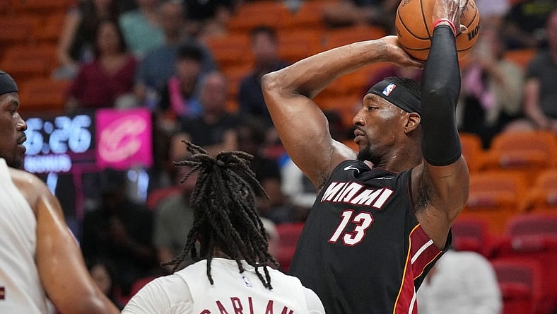 Mar 24, 2024; Miami, Florida, USA;  Miami Heat center Bam Adebayo (13) looks to pass the ball against the Cleveland Cavaliers defense during the first half at Kaseya Center. Mandatory Credit: Jim Rassol-USA TODAY Sports