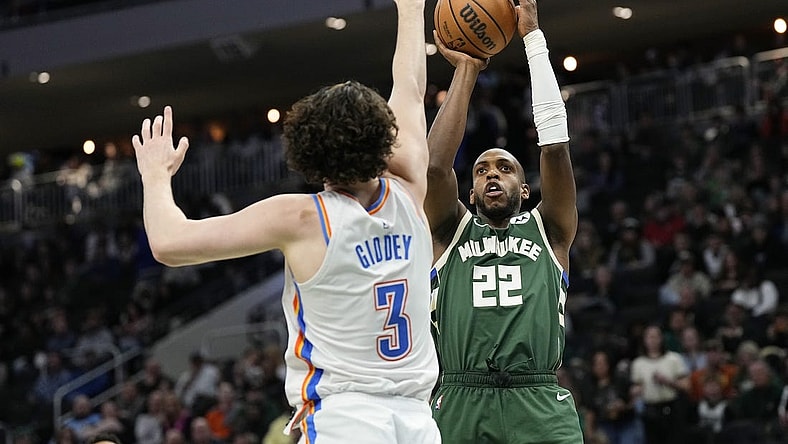 Mar 24, 2024; Milwaukee, Wisconsin, USA;  Milwaukee Bucks forward Khris Middleton (22) shoots against Oklahoma City Thunder guard Josh Giddey (3) during the third quarter at Fiserv Forum. Mandatory Credit: Jeff Hanisch-USA TODAY Sports