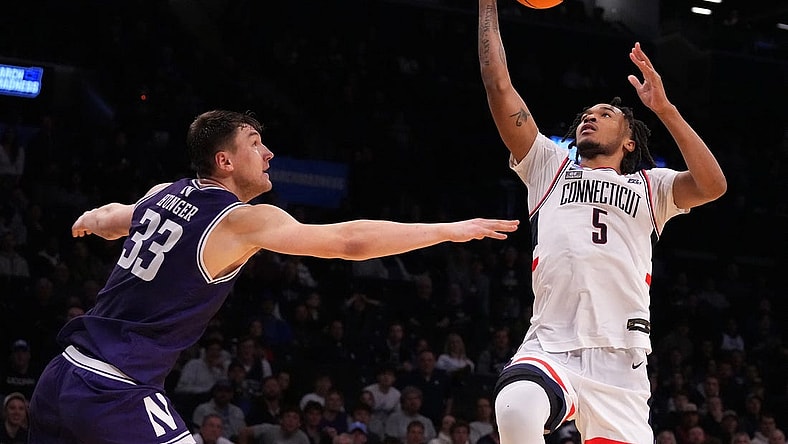 Mar 24, 2024; Brooklyn, NY, USA; Connecticut Huskies guard Stephon Castle (5) shoots the ball over Northwestern Wildcats forward Luke Hunger (33) in the second round of the 2024 NCAA Tournament at the Barclays Center. Mandatory Credit: Robert Deutsch-USA TODAY Sports
