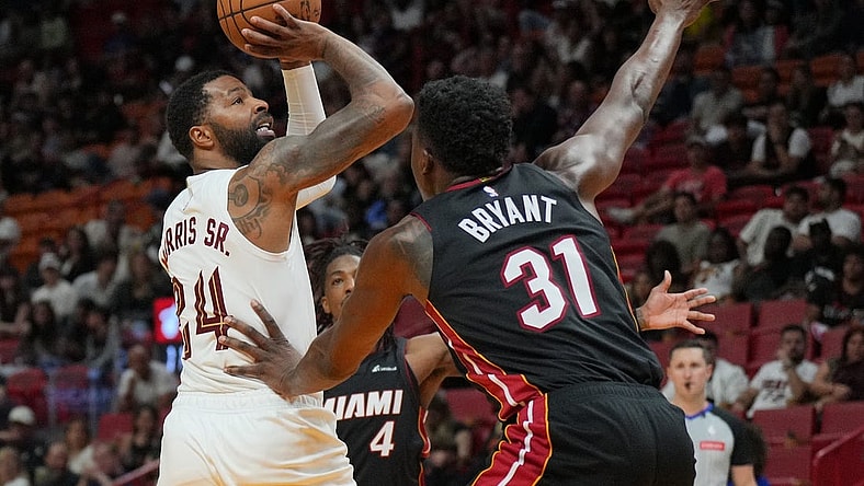 Mar 24, 2024; Miami, Florida, USA;  Cleveland Cavaliers forward Marcus Morris Sr. (24) takes a shot over Miami Heat center Thomas Bryant (31) during the second half at Kaseya Center. Mandatory Credit: Jim Rassol-USA TODAY Sports