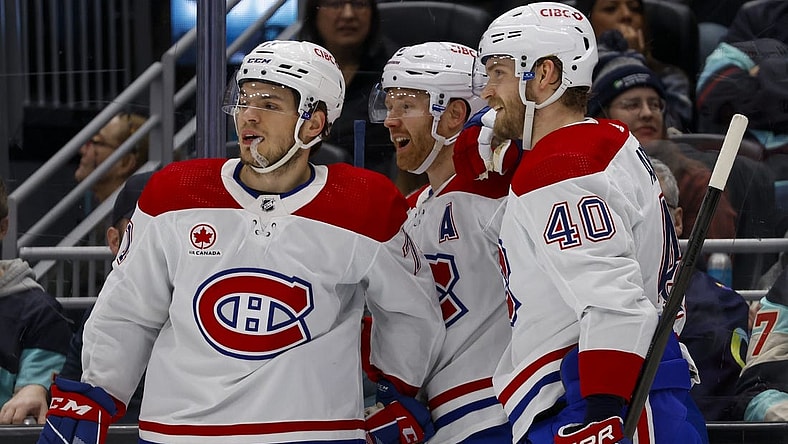 Mar 24, 2024; Seattle, Washington, USA; Montreal Canadiens defenseman Mike Matheson (8) celebrates with center Jake Evans (71, left) and right wing Joel Armia (40) after scoring a goal against the Seattle Kraken during the second period at Climate Pledge Arena. Mandatory Credit: Joe Nicholson-USA TODAY Sports