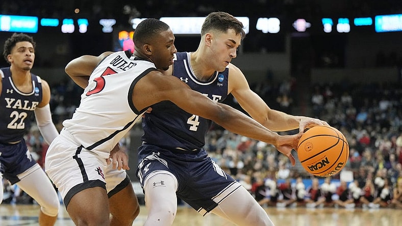 Mar 24, 2024; Spokane, WA, USA; Yale Bulldogs guard John Poulakidas (4) battles San Diego State Aztecs guard Lamont Butler (5) for the ball in the second half at Spokane Veterans Memorial Arena. Mandatory Credit: Kirby Lee-USA TODAY Sports