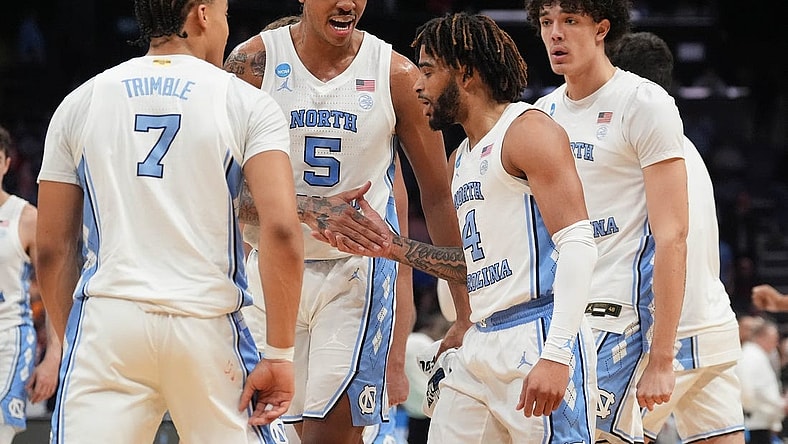 Mar 23, 2024; Charlotte, NC, USA;  North Carolina Tar Heels forward Armando Bacot (5) congratulates guard RJ Davis (4) after hitting a three point shot against Michigan State Spartans at Spectrum Center. Mandatory Credit: Jim Dedmon-USA TODAY Sports