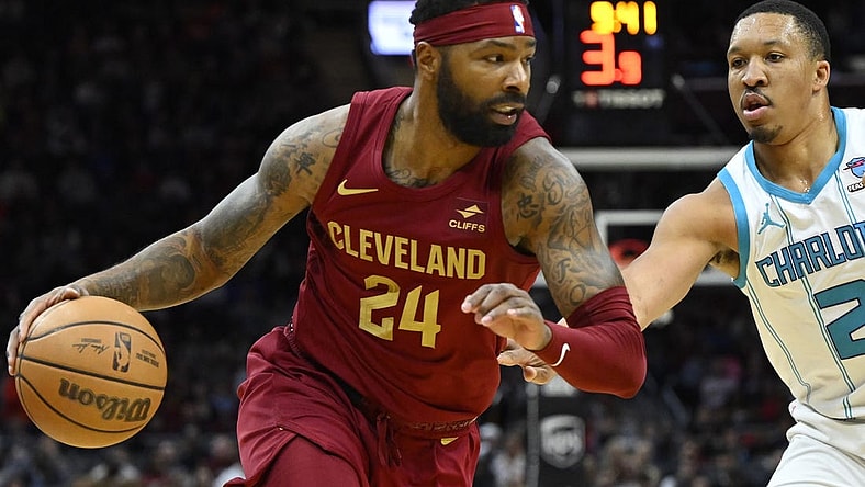 Mar 25, 2024; Cleveland, Ohio, USA; Cleveland Cavaliers forward Marcus Morris Sr. (24) dribbles beside Charlotte Hornets forward Grant Williams (2) in the second quarter at Rocket Mortgage FieldHouse. Mandatory Credit: David Richard-USA TODAY Sports