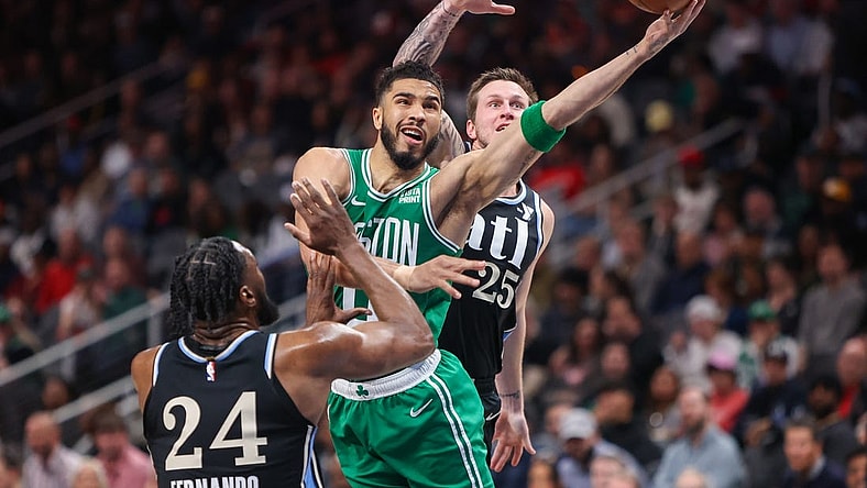 Mar 25, 2024; Atlanta, Georgia, USA; Boston Celtics forward Jayson Tatum (0) shoots past Atlanta Hawks forward Bruno Fernando (24) and guard Garrison Mathews (25) in the second quarter at State Farm Arena. Mandatory Credit: Brett Davis-USA TODAY Sports