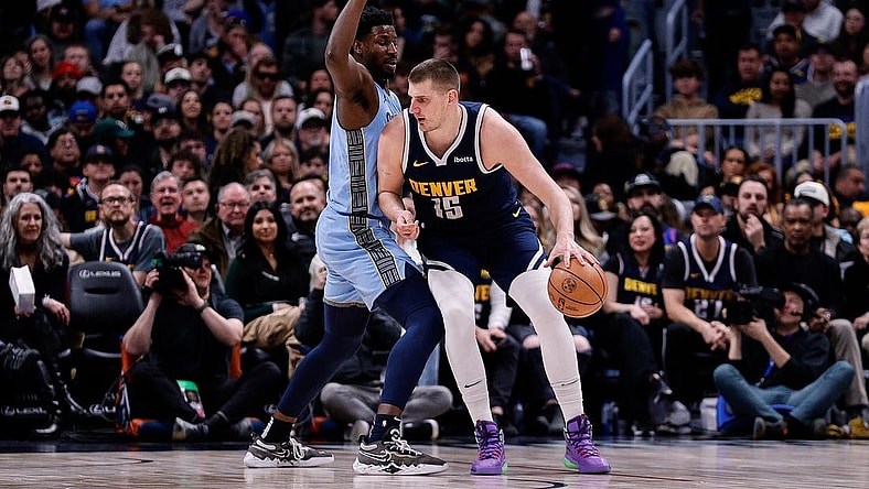 Mar 25, 2024; Denver, Colorado, USA; Denver Nuggets center Nikola Jokic (15) controls the ball against Memphis Grizzlies forward Jaren Jackson Jr. (13) in the second quarter at Ball Arena. Mandatory Credit: Isaiah J. Downing-USA TODAY Sports
