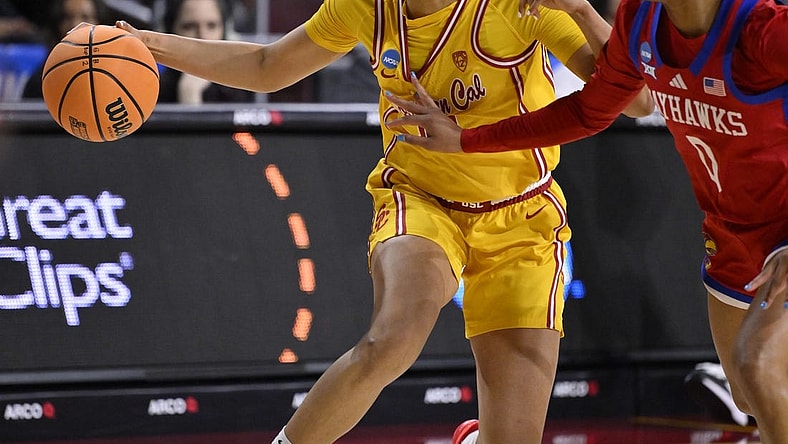 Mar 25, 2024; Los Angeles, CA, USA; USC Trojans guard JuJu Watkins (12) drives to the basket as Kansas Jayhawks guard Wyvette Mayberry (0) defends during an NCAA Women’s Tournament 2nd round game at Galen Center. Mandatory Credit: Robert Hanashiro-USA TODAY Sports