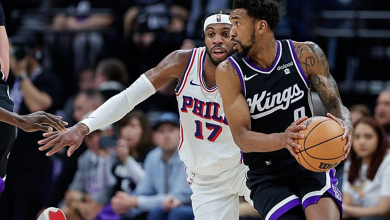 Mar 25, 2024; Sacramento, California, USA; Sacramento Kings guard Malik Monk (0) controls the ball against Philadelphia 76ers guard Buddy Hield (17) during the second quarter at Golden 1 Center. Mandatory Credit: Sergio Estrada-USA TODAY Sports
