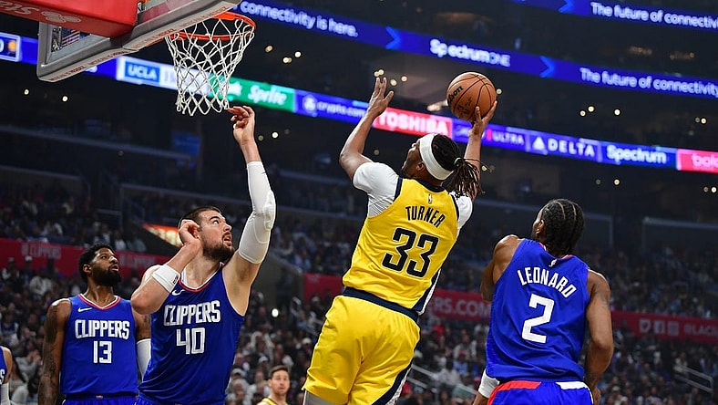 Mar 25, 2024; Los Angeles, California, USA; Indiana Pacers center Myles Turner (33) shoots against Los Angeles Clippers center Ivica Zubac (40) and forward Kawhi Leonard (2) during the first half at Crypto.com Arena. Mandatory Credit: Gary A. Vasquez-USA TODAY Sports