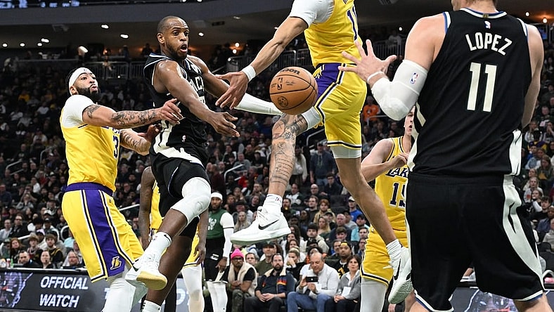 Mar 26, 2024; Milwaukee, Wisconsin, USA; Milwaukee Bucks forward Khris Middleton (22) drives tot the basket against Los Angeles Lakers center Jaxson Hayes (11) in the first half at Fiserv Forum. Mandatory Credit: Michael McLoone-USA TODAY Sports