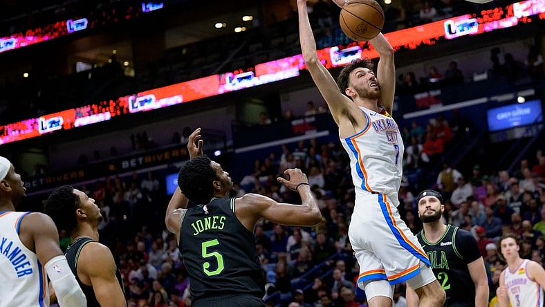 Mar 26, 2024; New Orleans, Louisiana, USA; Oklahoma City Thunder forward Chet Holmgren (7) dunks against New Orleans Pelicans forward Herbert Jones (5) during the first half at Smoothie King Center. Mandatory Credit: Matthew Hinton-USA TODAY Sports