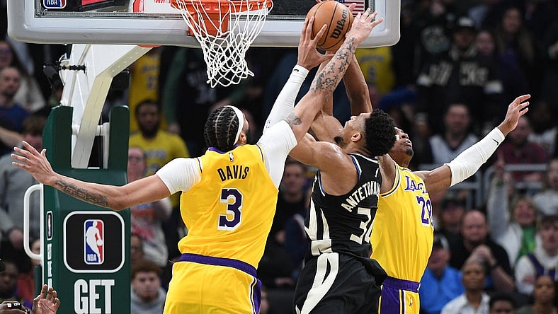 Mar 26, 2024; Milwaukee, Wisconsin, USA; Milwaukee Bucks forward Giannis Antetokounmpo (34) puts up a shot against Los Angeles Lakers forward Anthony Davis (3) and Los Angeles Lakers forward Rui Hachimura (28) in the second overtime at Fiserv Forum. Mandatory Credit: Michael McLoone-USA TODAY Sports
