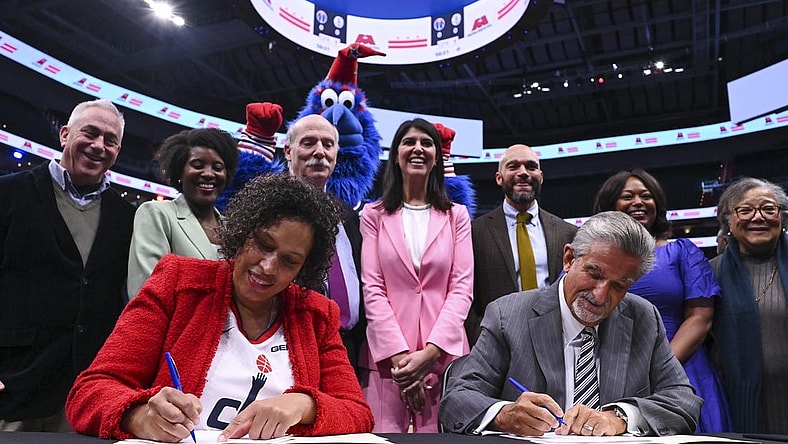Mar 27, 2024; Washington, District of Columbia, USA;  Washington DC mayor Muriel Bowser  and Monumental Sports & Entertainment CEO Ted Leonsis sign an agreement on the court before the game between the Brooklyn Nets and the Washington Wizards at Capital One Arena. Mandatory Credit: Tommy Gilligan-USA TODAY Sports