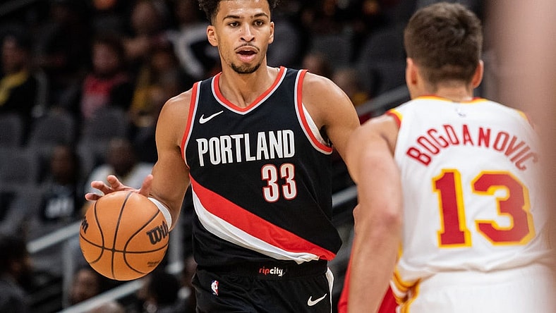 Mar 27, 2024; Atlanta, Georgia, USA; Portland Trail Blazers forward Toumani Camara (33) dribbles the ball against Atlanta Hawks guard Bogdan Bogdanovic (13) during the first quarter at State Farm Arena. Mandatory Credit: Jordan Godfree-USA TODAY Sports