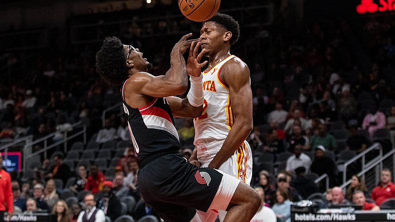 Mar 27, 2024; Atlanta, Georgia, USA; Atlanta Hawks forward De'Andre Hunter (12) defends the basket against Portland Trail Blazers guard Scoot Henderson (00) during the first quarter at State Farm Arena. Mandatory Credit: Jordan Godfree-USA TODAY Sports