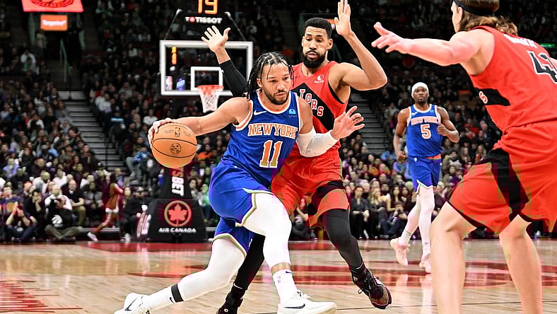 Mar 27, 2024; Toronto, Ontario, CAN;   New York Knicks guard Jalen Brunson (11) dribbles the ball against Toronto Raptors guard Garrett Temple (17) in the first half at Scotiabank Arena. Mandatory Credit: Dan Hamilton-USA TODAY Sports