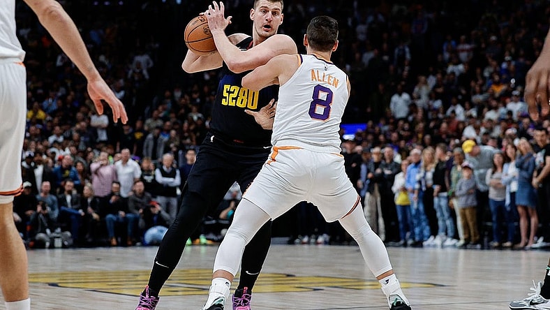 Mar 27, 2024; Denver, Colorado, USA; Denver Nuggets center Nikola Jokic (15) controls the ball as Denver Nuggets forward Peyton Watson (8) guards in the first quarter at Ball Arena. Mandatory Credit: Isaiah J. Downing-USA TODAY Sports