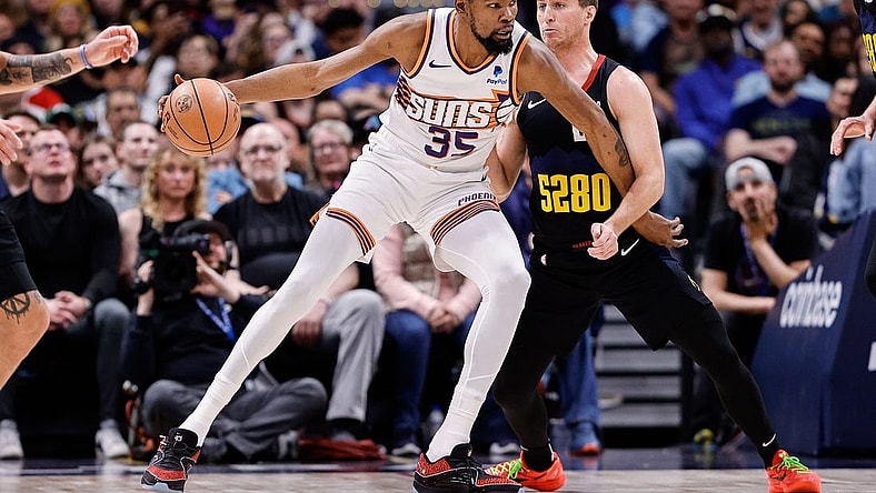 Mar 27, 2024; Denver, Colorado, USA; Phoenix Suns forward Kevin Durant (35) controls the ball as Denver Nuggets guard Collin Gillespie (21) guards in the second quarter at Ball Arena. Mandatory Credit: Isaiah J. Downing-USA TODAY Sports