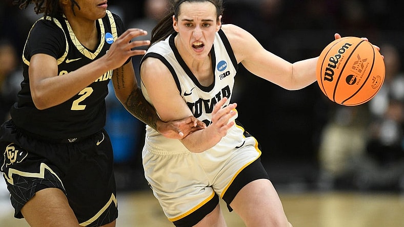 Iowa's Caitlin Clark (22) tries to get to the basket while guarded by Colorado's Tameiya Sadler (2) during the Sweet 16 of the NCAA college basketball tournament at Climate Pledge Arena in Seattle, WA on Friday, March 24, 2023.