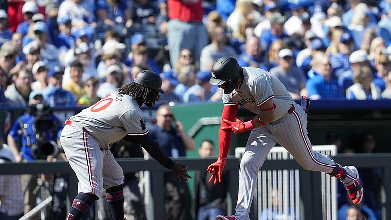 Mar 28, 2024; Kansas City, Missouri, USA; Minnesota Twins third baseman Royce Lewis (23) celebrates with third base coach Tommy Watkins after hitting a home run during the first inning against the Kansas City Royals at Kauffman Stadium. Mandatory Credit: Jay Biggerstaff-USA TODAY Sports