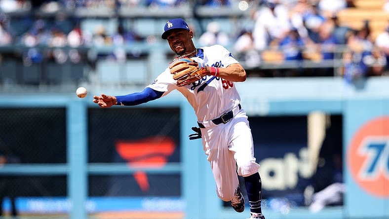 Mar 28, 2024; Los Angeles, California, USA; Los Angeles Dodgers outfielder Mookie Betts (50) throws to first for an out during the third inning of an opening day game against the St. Louis Cardinals at Dodger Stadium. Mandatory Credit: Jason Parkhurst-USA TODAY Sports