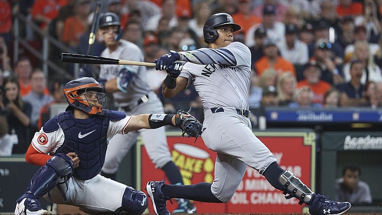 Mar 28, 2024; Houston, Texas, USA; New York Yankees right fielder Juan Soto (22) hits an RBI single during the fifth inning against the Houston Astros at Minute Maid Park. Mandatory Credit: Troy Taormina-USA TODAY Sports