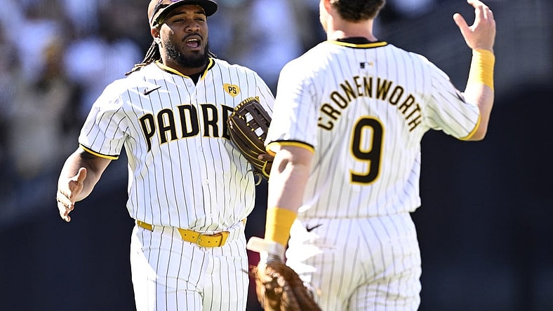 Mar 28, 2024; San Diego, California, USA; San Diego Padres third baseman Eguy Rosario (5) and first baseman Jake Cronenworth (9) celebrate on the field after defeating the San Francisco Giants at Petco Park. Mandatory Credit: Orlando Ramirez-USA TODAY Sports