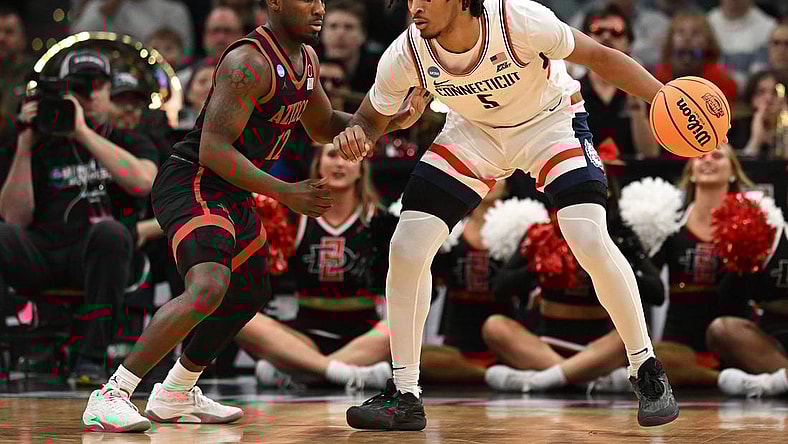 Mar 28, 2024; Boston, MA, USA; Connecticut Huskies guard Stephon Castle (5) dribbles the ball against San Diego State Aztecs guard Darrion Trammell (12) in the semifinals of the East Regional of the 2024 NCAA Tournament at TD Garden. Mandatory Credit: Brian Fluharty-USA TODAY Sports