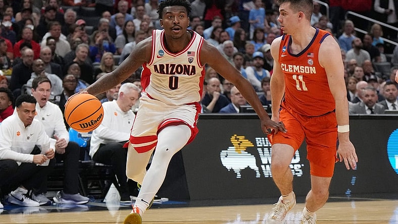 Mar 28, 2024; Los Angeles, CA, USA; Arizona Wildcats guard Jaden Bradley (0) controls the ball against Clemson Tigers guard Joseph Girard III (11) in the first half in the semifinals of the West Regional of the 2024 NCAA Tournament at Crypto.com Arena. Mandatory Credit: Kirby Lee-USA TODAY Sports