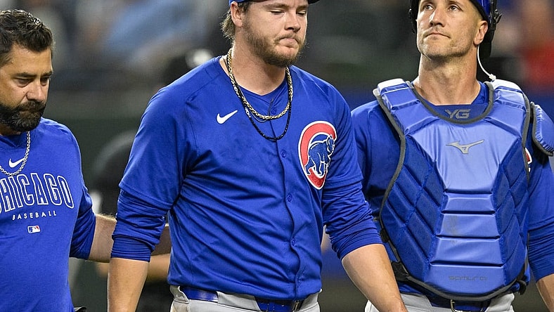 Mar 31, 2024; Arlington, Texas, USA; Chicago Cubs starting pitcher Justin Steele (35) and catcher Yan Gomes (15) walk off the field after Steele suffers an injury during the fifth inning against the Texas Rangers at Globe Life Field. Mandatory Credit: Jerome Miron-USA TODAY Sports