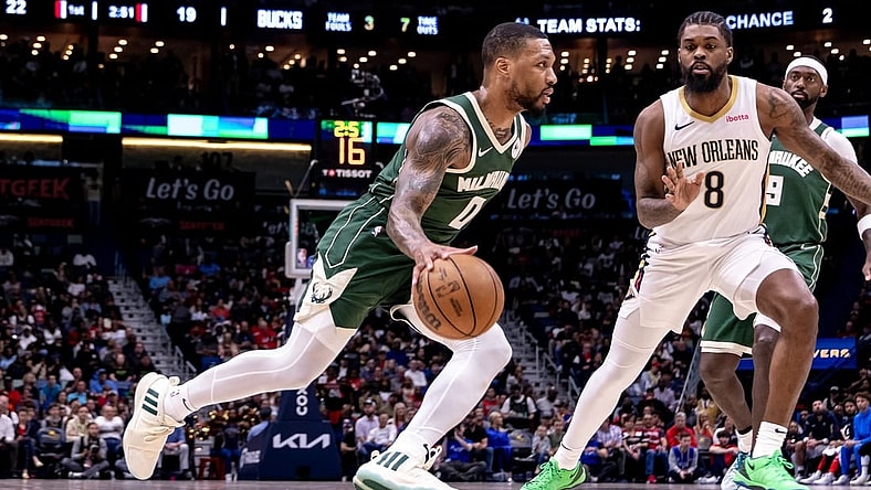 Mar 28, 2024; New Orleans, Louisiana, USA;  Milwaukee Bucks guard Damian Lillard (0) dribbles against New Orleans Pelicans forward Naji Marshall (8) during the first half at Smoothie King Center. Mandatory Credit: Stephen Lew-USA TODAY Sports