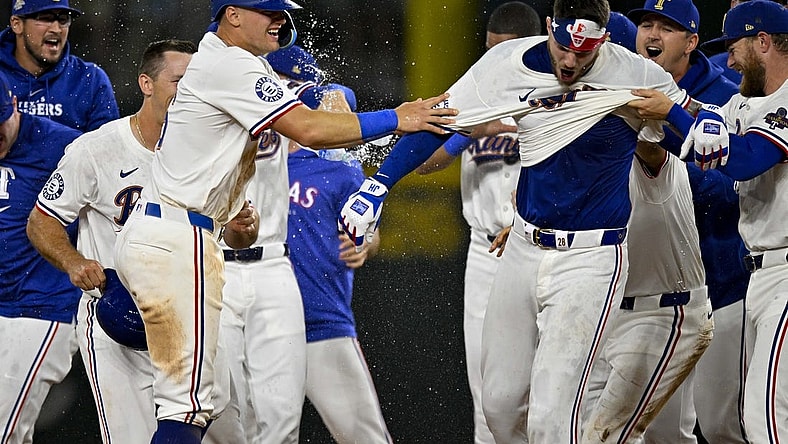 Mar 31, 2024; Arlington, Texas, USA; Texas Rangers catcher Jonah Heim (28) and third baseman Josh Jung (6) celebrate after Heim hits a walk off single against the Chicago Cubs during the tenth inning at Globe Life Field. Mandatory Credit: Jerome Miron-USA TODAY Sports