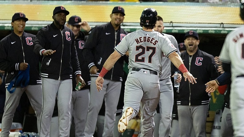 Mar 28, 2024; Oakland, California, USA; Cleveland Guardians catcher Austin Hedges (27) is greeted by his teammates after scoring on a two-RBI double by Brayan Rocchio against the Oakland Athletics during the fourth inning at Oakland-Alameda County Coliseum. Mandatory Credit: D. Ross Cameron-USA TODAY Sports