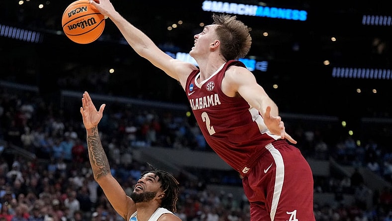Mar 28, 2024; Los Angeles, CA, USA; Alabama Crimson Tide forward Grant Nelson (2) blocks North Carolina Tar Heels guard RJ Davis (4) in the second half in the semifinals of the West Regional of the 2024 NCAA Tournament at Crypto.com Arena. Mandatory Credit: Kirby Lee-USA TODAY Sports