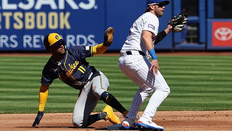 Mar 29, 2024; New York City, New York, USA; Milwaukee Brewers right fielder Jackson Chourio (11) calls for time after stealing second base behind New York Mets second baseman Jeff McNeil (1) before the game at Citi Field. Mandatory Credit: Vincent Carchietta-USA TODAY Sports