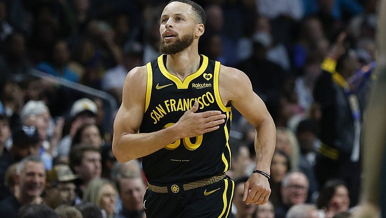 Mar 29, 2024; Charlotte, North Carolina, USA; Golden State Warriors guard Stephen Curry (30) pats his chest after making a three-point basket against the Charlotte Hornets during the first quarter at Spectrum Center. Mandatory Credit: Nell Redmond-USA TODAY Sports
