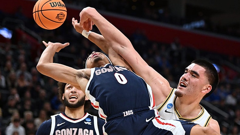 Mar 29, 2024; Detroit, MN, USA; Gonzaga Bulldogs guard Ryan Nembhard (0) battles Purdue Boilermakers center Zach Edey (15) for the ball in the first half during the NCAA Tournament Midwest Regional at Little Caesars Arena. Mandatory Credit: Lon Horwedel-USA TODAY Sports