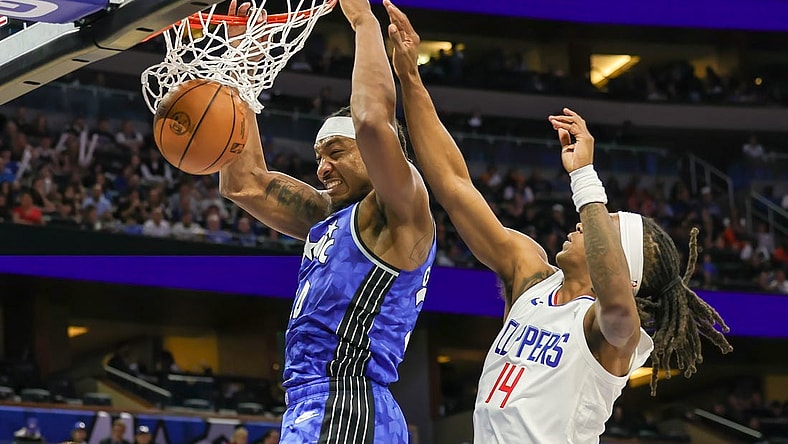 Mar 29, 2024; Orlando, Florida, USA; Orlando Magic center Wendell Carter Jr. (34) dunks in front of LA Clippers guard Terance Mann (14) during the second quarter at KIA Center. Mandatory Credit: Mike Watters-USA TODAY Sports
