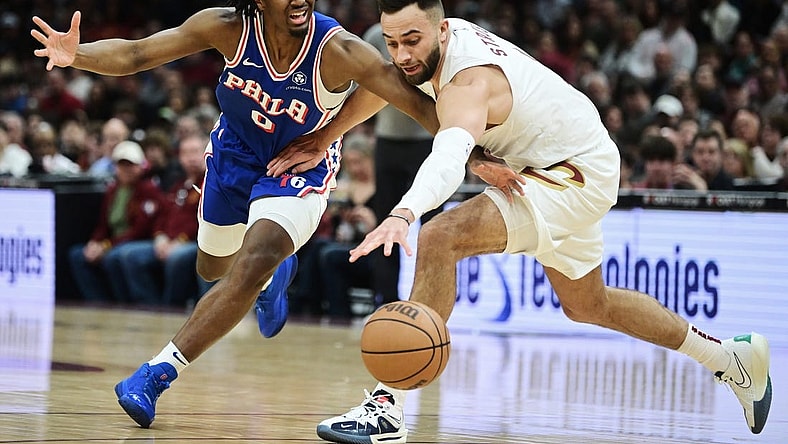 Mar 29, 2024; Cleveland, Ohio, USA; Philadelphia 76ers guard Tyrese Maxey (0) and Cleveland Cavaliers guard Max Strus (1) go for a loose ball during the first half at Rocket Mortgage FieldHouse. Mandatory Credit: Ken Blaze-USA TODAY Sports