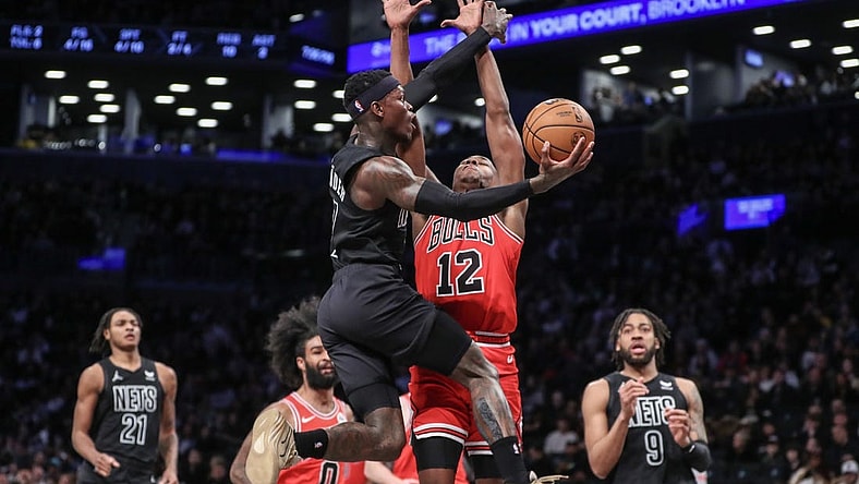 Mar 29, 2024; Brooklyn, New York, USA; Brooklyn Nets guard Dennis Schroder (17) drives past Chicago Bulls guard Ayo Dosunmu (12) in the first quarter at Barclays Center. Mandatory Credit: Wendell Cruz-USA TODAY Sports