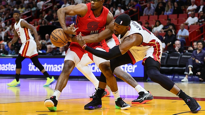 Mar 29, 2024; Miami, Florida, USA; Portland Trail Blazers guard Scoot Henderson (00) and Miami Heat center Bam Adebayo (13) battle for possession during the first quarter at Kaseya Center. Mandatory Credit: Sam Navarro-USA TODAY Sports