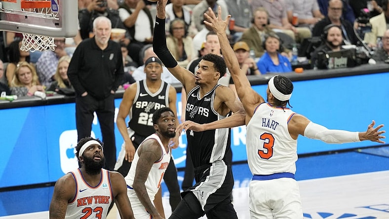 Mar 29, 2024; San Antonio, Texas, USA; San Antonio Spurs forward Victor Wembanyama (1) goes up to dunk over New York Knicks center Mitchell Robinson (23) and forward Josh Hart (3) during the first half at Frost Bank Center. Mandatory Credit: Scott Wachter-USA TODAY Sports