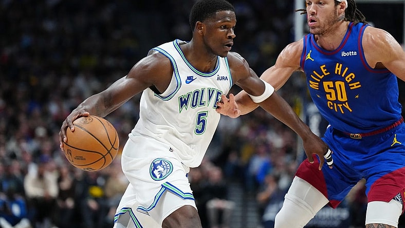 Mar 29, 2024; Denver, Colorado, USA; Minnesota Timberwolves guard Anthony Edwards (5) drives at Denver Nuggets forward Aaron Gordon (50) in the second quarter at Ball Arena. Mandatory Credit: Ron Chenoy-USA TODAY Sports