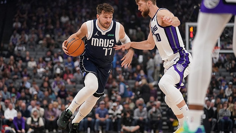 Mar 29, 2024; Sacramento, California, USA; Dallas Mavericks guard Luka Doncic (77) dribbles next to Sacramento Kings forward Domantas Sabonis (10) in the first quarter at the Golden 1 Center. Mandatory Credit: Cary Edmondson-USA TODAY Sports