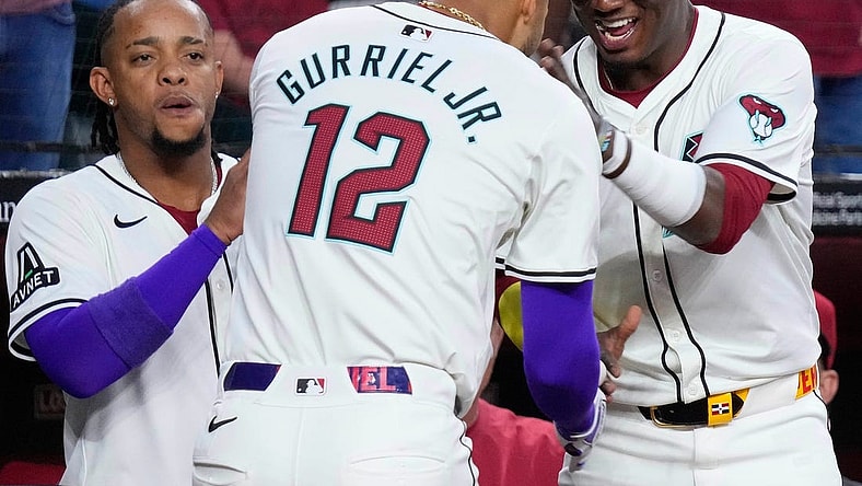 Diamondbacks Lourdes Gurriel Jr. (12) celebrates a home run against the Rockies with teammate Geraldo Perdomo (R) in the first inning during a game at Chase Field on March 29, 2024.